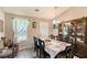 Formal dining room includes a large table with seating for eight and a china cabinet at 25 Bridlewood Ct, Stockbridge, GA 30281