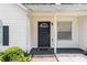 A close-up of the home's entrance, featuring a dark front door and small front porch at 25 Bridlewood Ct, Stockbridge, GA 30281