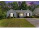 Charming one-story home boasts a well-maintained lawn and colorful flowering bushes at 25 Bridlewood Ct, Stockbridge, GA 30281