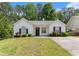 Charming one-story home boasts a well-maintained lawn and colorful flowering bushes at 25 Bridlewood Ct, Stockbridge, GA 30281