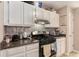 Cozy kitchen featuring a stainless steel range, granite countertops and neutral backsplash at 25 Bridlewood Ct, Stockbridge, GA 30281