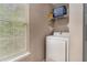 Convenient laundry area equipped with a washer, storage shelves, and a window at 25 Bridlewood Ct, Stockbridge, GA 30281