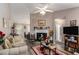 Cozy living room with a fireplace, ceiling fan, and plush sofas at 25 Bridlewood Ct, Stockbridge, GA 30281