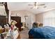 Main bedroom with a ceiling fan and view of the entry door and large wardrobe at 25 Bridlewood Ct, Stockbridge, GA 30281