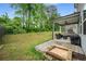 Well-maintained backyard features a covered patio with outdoor seating and lush greenery at 4422 Richmond Se Ct, Stone Mountain, GA 30083