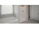 Well-lit bathroom featuring a tub, shower, and modern fixtures at 4422 Richmond Se Ct, Stone Mountain, GA 30083
