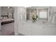 Bathroom with double vanity, white cabinets, and view into the bedroom at 4422 Richmond Se Ct, Stone Mountain, GA 30083