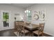Charming dining room with a rustic table, elegant lighting, and a view to the backyard at 4422 Richmond Se Ct, Stone Mountain, GA 30083