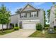 Charming two-story home with gray siding, a two-car garage, and a well-manicured lawn at 4422 Richmond Se Ct, Stone Mountain, GA 30083