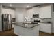 Modern kitchen featuring granite countertops, stainless steel appliances, and ample cabinet space at 4422 Richmond Se Ct, Stone Mountain, GA 30083