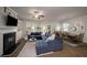Open-concept living room with a fireplace, adjacent dining area, and ample natural light at 4422 Richmond Se Ct, Stone Mountain, GA 30083