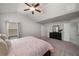 Bright main bedroom with a ceiling fan, vaulted ceiling, and ensuite bathroom at 4422 Richmond Se Ct, Stone Mountain, GA 30083