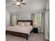 Spacious main bedroom featuring a ceiling fan, plush carpet, and large windows at 4422 Richmond Se Ct, Stone Mountain, GA 30083