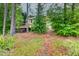Backyard exterior with a wooden deck and outdoor seating, surrounded by trees at 7737 Bar Harbor Dr, Riverdale, GA 30296