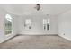 Spacious bedroom with carpet flooring, bright natural light, and arched windows at 7737 Bar Harbor Dr, Riverdale, GA 30296