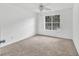 Comfortable bedroom featuring neutral walls, bright window, and ceiling fan at 7737 Bar Harbor Dr, Riverdale, GA 30296