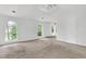 Bright bedroom featuring neutral walls, large arched windows, and cozy carpeting at 7737 Bar Harbor Dr, Riverdale, GA 30296
