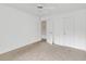 Bright bedroom features neutral carpet, white walls, two entry doors, and a ceiling fan at 7737 Bar Harbor Dr, Riverdale, GA 30296