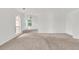 Bright bedroom showcasing neutral walls, large arched windows, and cozy carpeting at 7737 Bar Harbor Dr, Riverdale, GA 30296