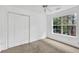 Comfortable bedroom with closet, bright window, and neutral wall color scheme at 7737 Bar Harbor Dr, Riverdale, GA 30296