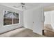 Comfortable bedroom featuring neutral walls, bright window, and an open doorway at 7737 Bar Harbor Dr, Riverdale, GA 30296