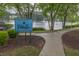 Welcome to The Villages sign with a view of the lake and walking trail at 7737 Bar Harbor Dr, Riverdale, GA 30296