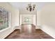 Dining area featuring wood floors, natural light, and views to other rooms in the house at 7737 Bar Harbor Dr, Riverdale, GA 30296