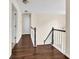 Hallway with gleaming hardwood floors, white trim, and staircase to the second floor at 7737 Bar Harbor Dr, Riverdale, GA 30296