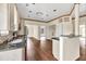 Open concept kitchen with stainless steel appliances, granite counters, and rich hardwood floors at 7737 Bar Harbor Dr, Riverdale, GA 30296