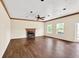 Spacious living room featuring hardwood floors and a brick fireplace at 7737 Bar Harbor Dr, Riverdale, GA 30296