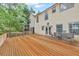 Spacious wooden deck with an outdoor dining set and ample seating at 7737 Bar Harbor Dr, Riverdale, GA 30296