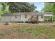 Expansive backyard featuring a patio area, mature trees, and lush greenery at 808 Casplan Sw St, Atlanta, GA 30310