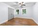 Bright bedroom with hardwood floors, two windows, ceiling fan, and a closet with bi-fold doors at 808 Casplan Sw St, Atlanta, GA 30310