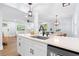 Modern open-concept kitchen featuring white cabinets, stone countertops, and stainless steel appliances at 808 Casplan Sw St, Atlanta, GA 30310