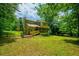 Expansive backyard featuring a screened porch and mature trees, perfect for outdoor enjoyment at 1131 Bailing Dr, Lawrenceville, GA 30043