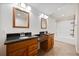Bright bathroom featuring double vanities with dark countertops and a bathtub with shower at 1131 Bailing Dr, Lawrenceville, GA 30043