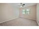 Bedroom with neutral carpeting, ceiling fan, and natural light from a window at 1131 Bailing Dr, Lawrenceville, GA 30043
