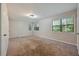 Spacious bedroom with large windows for natural light and neutral colored carpet at 1131 Bailing Dr, Lawrenceville, GA 30043