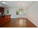 Dining area featuring hardwood floors, a chandelier, and large windows at 1131 Bailing Dr, Lawrenceville, GA 30043