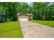 Charming home with stone accents, a well-manicured lawn, and an expansive driveway at 1131 Bailing Dr, Lawrenceville, GA 30043