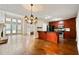 Open concept kitchen and living area with hardwood floors, breakfast bar, and stone fireplace at 1131 Bailing Dr, Lawrenceville, GA 30043