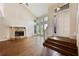 Bright living room with hardwood floors, stone fireplace, and large windows at 1131 Bailing Dr, Lawrenceville, GA 30043