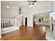 Open concept living room with hardwood floors, a fireplace, and a staircase at 1131 Bailing Dr, Lawrenceville, GA 30043