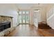 Bright living room with hardwood floors, stone fireplace, and large windows at 1131 Bailing Dr, Lawrenceville, GA 30043
