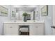 Elegant bathroom vanity with double sinks, vanity seating, and ample counter space at 2815 Habibi Ct, Buford, GA 30519