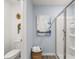 Bathroom with a toilet, framed art, and glass door shower with built-in shelves at 2815 Habibi Ct, Buford, GA 30519
