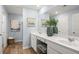 Light and airy bathroom with double sink vanity, framed art, and wood look floors at 2815 Habibi Ct, Buford, GA 30519