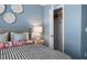 Cozy bedroom showcasing a closet, stylish decor, and soft, blue walls at 2815 Habibi Ct, Buford, GA 30519