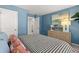 Comfortable bedroom featuring a stylish bed, sleek dresser, and soft, blue walls at 2815 Habibi Ct, Buford, GA 30519