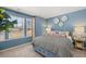 Bedroom with a black and white patterned comforter, side table, and large window at 2815 Habibi Ct, Buford, GA 30519